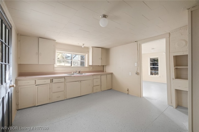 kitchen featuring cream cabinetry and sink