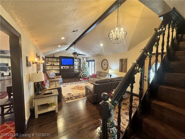 living room with dark hardwood / wood-style flooring, ceiling fan with notable chandelier, a textured ceiling, lofted ceiling with beams, and built in features