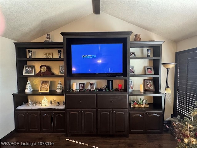 living room featuring vaulted ceiling with beams, dark hardwood / wood-style floors, and a textured ceiling