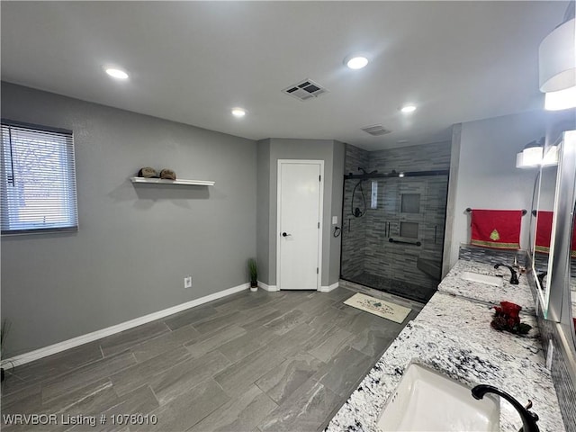 bathroom featuring vanity and a shower with door