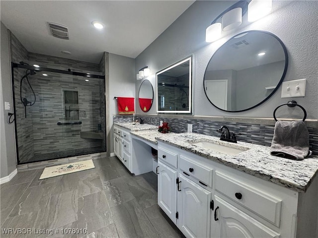 bathroom with tasteful backsplash, a shower with door, and vanity