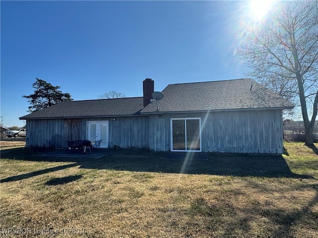 rear view of house with a yard