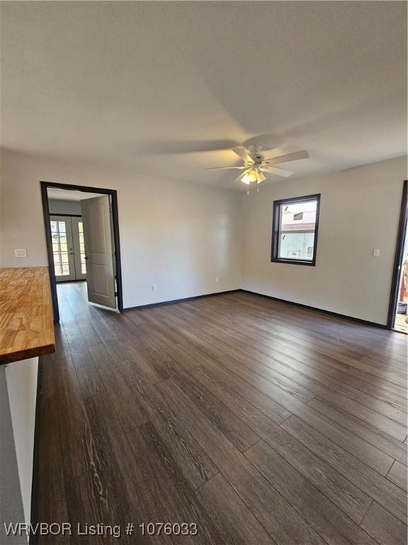 unfurnished room featuring ceiling fan and dark hardwood / wood-style floors