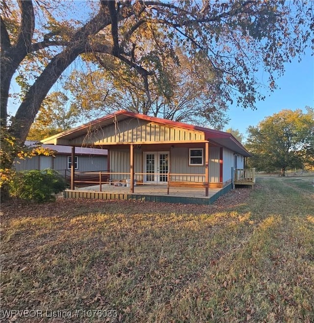 exterior space with french doors and a yard