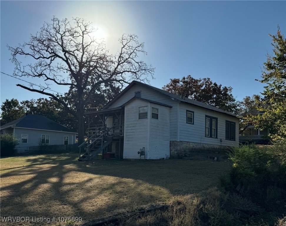 view of side of home with a lawn