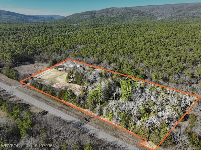 drone / aerial view with a mountain view and a view of trees