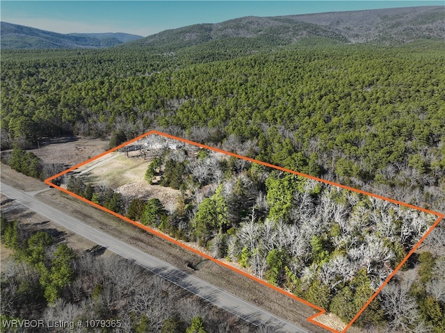 drone / aerial view with a mountain view and a view of trees