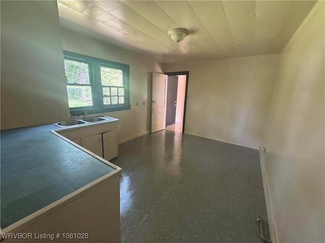1025 Henry St, Alma, AR 72921 - kitchen with a sink, white cabinetry, and baseboards