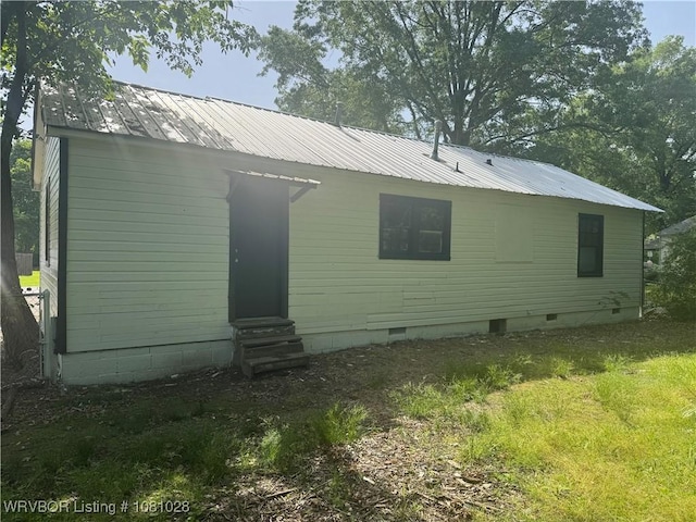 1025 Henry St, Alma, AR 72921 - back of property with entry steps, crawl space, metal roof, and a lawn