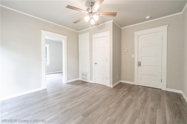 408 Denver St, Greenwood, AR 72936 - empty room featuring a ceiling fan, light wood-style flooring, baseboards, crown molding, and a smoke detector