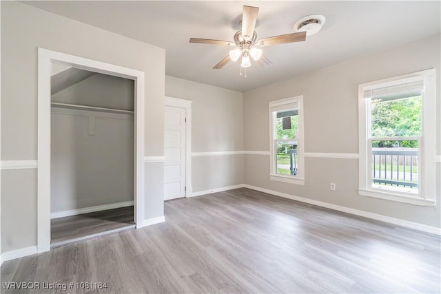 408 Denver St, Greenwood, AR 72936 - unfurnished bedroom with wood finished floors, a closet, baseboards, and a ceiling fan