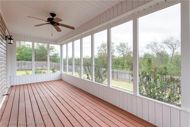 unfurnished sunroom featuring ceiling fan