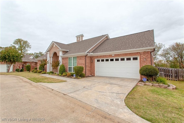 view of front of home with a front lawn and a garage