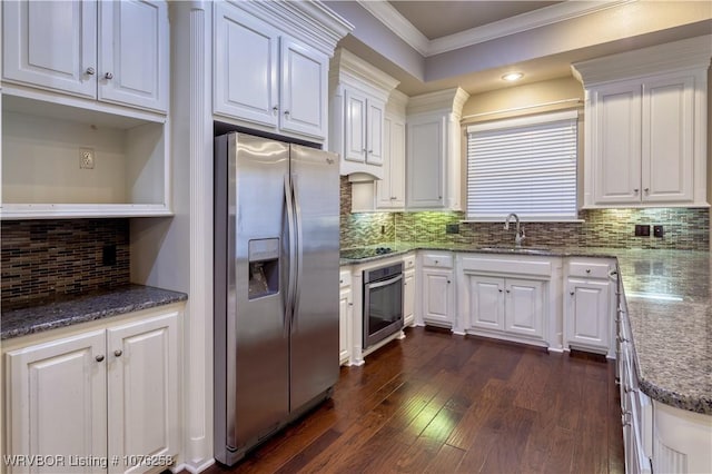 kitchen with white cabinets, backsplash, stainless steel appliances, and sink