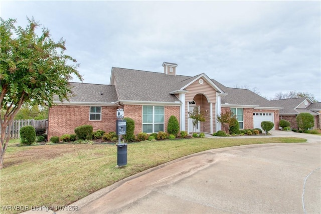 view of front of property with a front yard and a garage