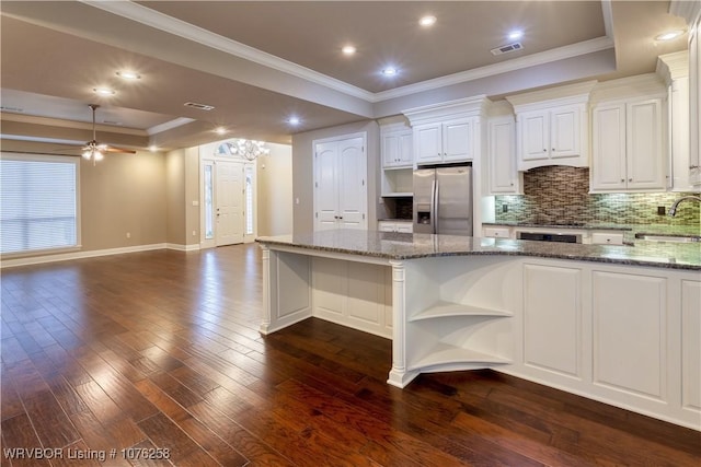 kitchen with ceiling fan, white cabinets, dark stone counters, and stainless steel refrigerator with ice dispenser