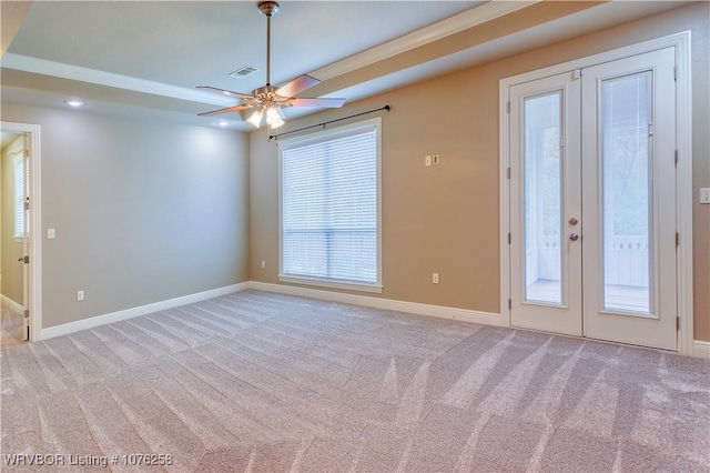 carpeted empty room with french doors, ceiling fan, and ornamental molding