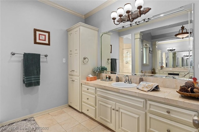 bathroom with baseboards, ornamental molding, an inviting chandelier, tile patterned floors, and vanity