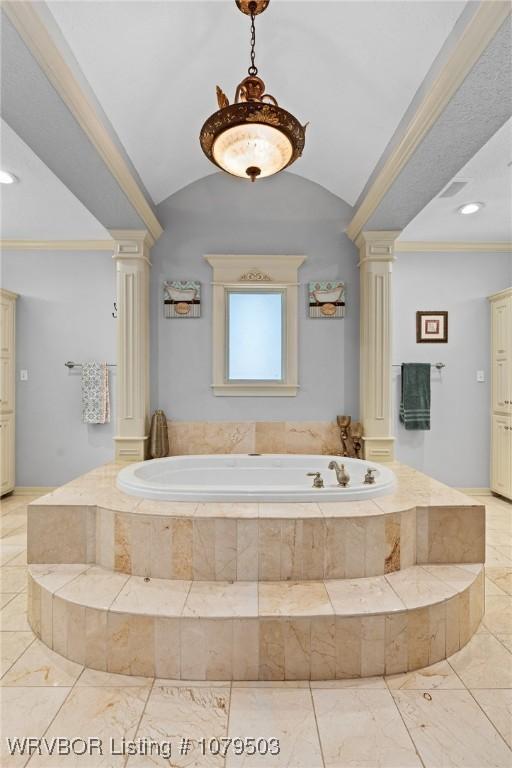 full bath featuring crown molding, a garden tub, and ornate columns