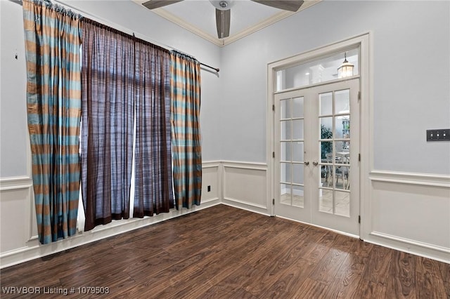 unfurnished room with a wainscoted wall, wood finished floors, french doors, crown molding, and ceiling fan