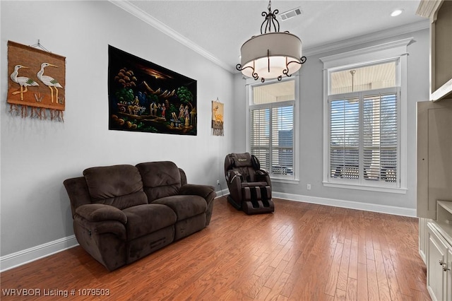 sitting room featuring crown molding, hardwood / wood-style flooring, baseboards, and visible vents