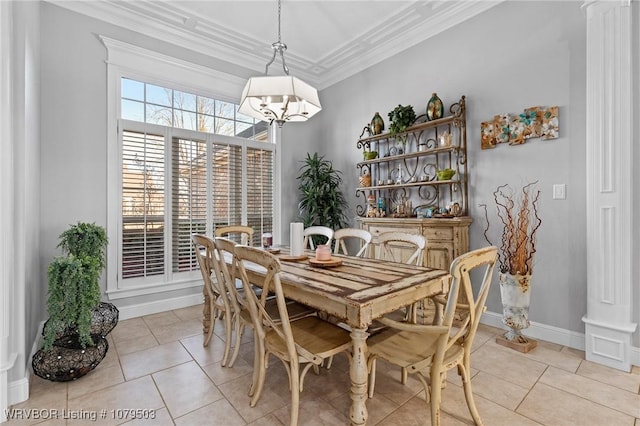 dining room featuring light tile patterned floors, decorative columns, an inviting chandelier, and ornamental molding