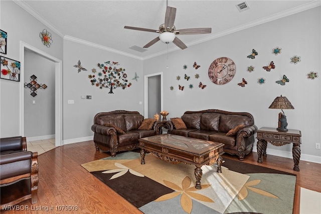 living room featuring visible vents, baseboards, ceiling fan, ornamental molding, and wood finished floors