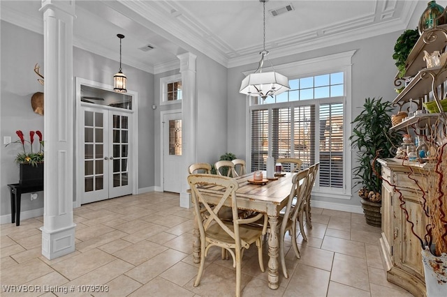 dining space featuring baseboards, visible vents, ornate columns, an inviting chandelier, and ornamental molding