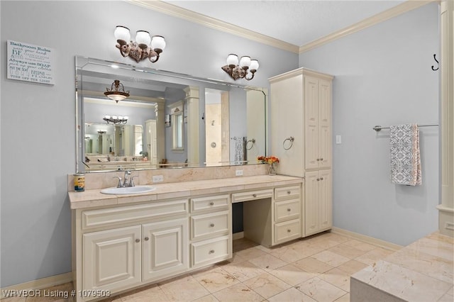 bathroom with vanity, crown molding, and baseboards