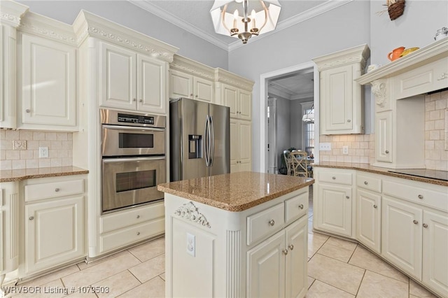 kitchen with a notable chandelier, a center island, appliances with stainless steel finishes, crown molding, and light tile patterned floors