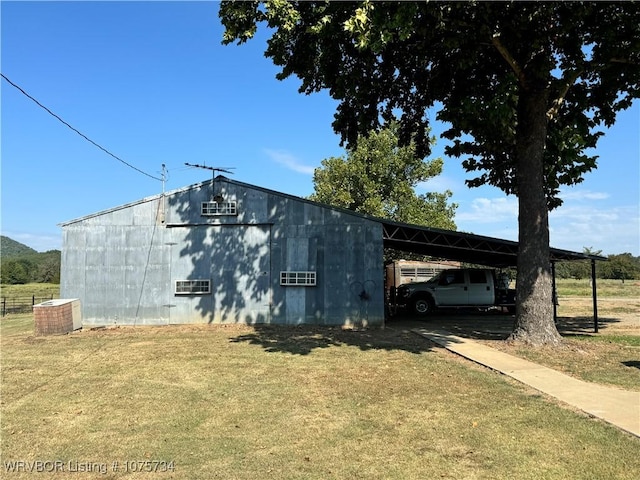 view of outdoor structure featuring a lawn and cooling unit