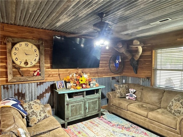 living room with wooden walls and wooden ceiling