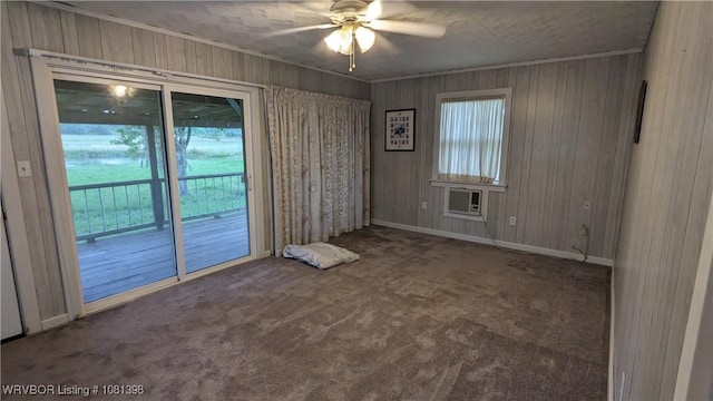 3701 S Cook Rd, Charleston, AR 72933 - carpeted spare room featuring ceiling fan, wood walls, an AC wall unit, and baseboards