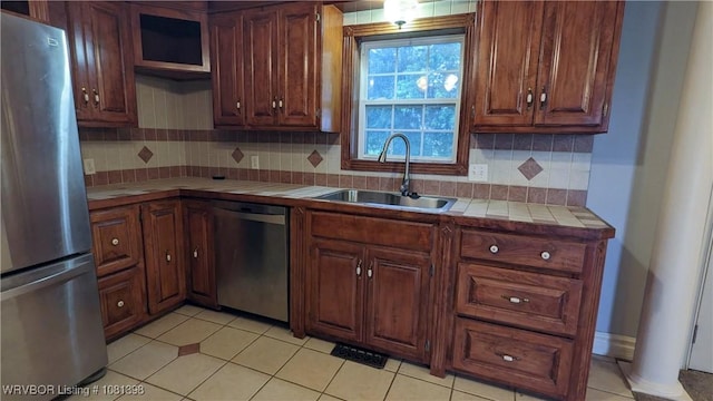 3701 S Cook Rd, Charleston, AR 72933 - kitchen with stainless steel appliances, tile countertops, a sink, and tasteful backsplash