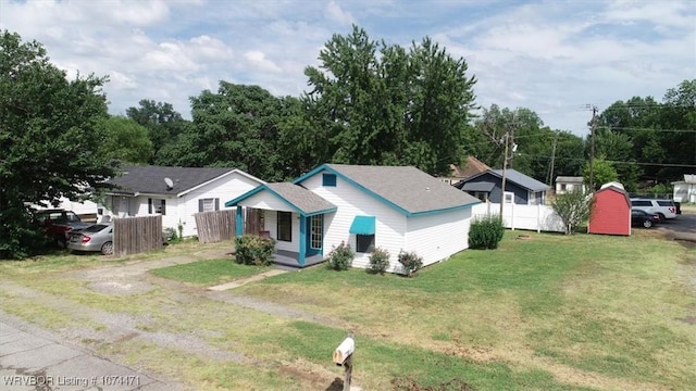 ranch-style house with a porch and a front lawn