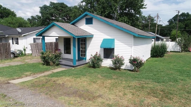 back of house featuring a porch and a yard