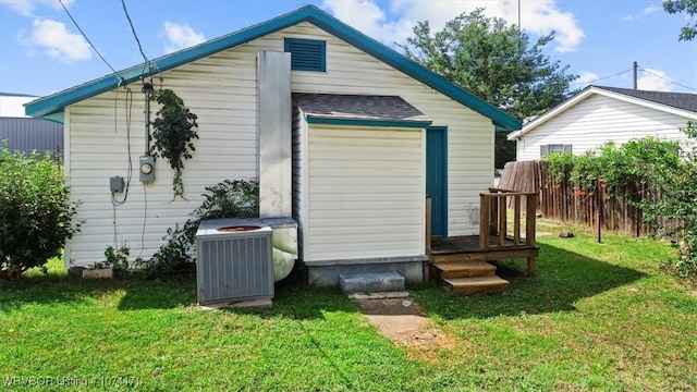 view of outdoor structure featuring a yard and cooling unit