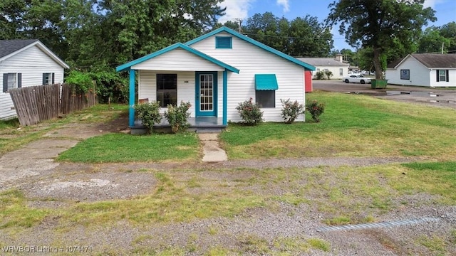 bungalow-style house with a front lawn