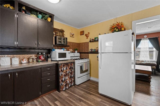 kitchen featuring white appliances and dark wood-style flooring