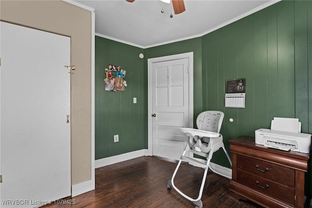 office space with baseboards, a ceiling fan, dark wood finished floors, and crown molding