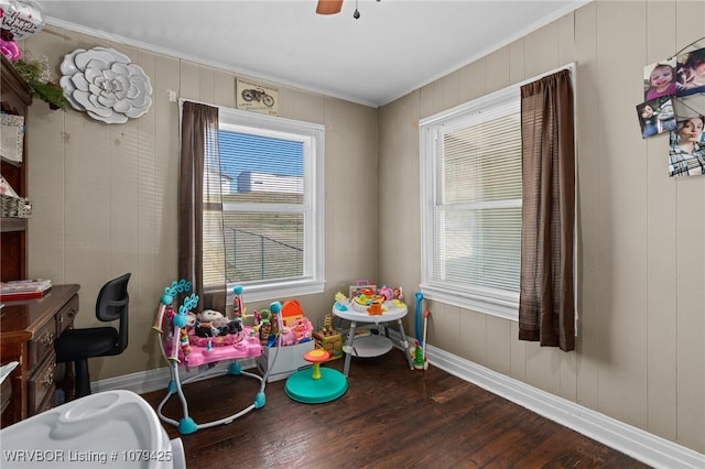 game room with baseboards, a ceiling fan, wood finished floors, and crown molding