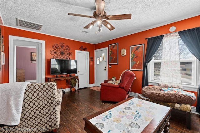 living area with ceiling fan, visible vents, a textured ceiling, and wood finished floors