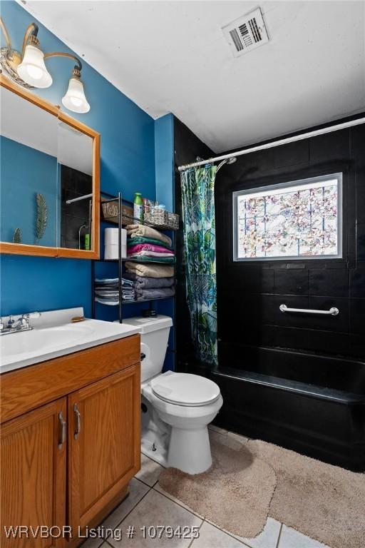 full bath featuring vanity, visible vents, shower / tub combo, tile patterned floors, and toilet