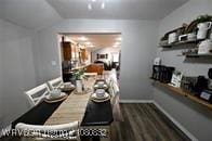 dining area featuring dark wood-type flooring and baseboards