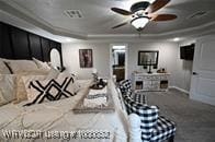 carpeted home theater featuring a raised ceiling and ornamental molding