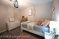 bedroom with a notable chandelier