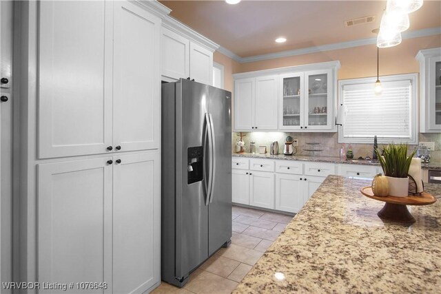 kitchen featuring stainless steel fridge with ice dispenser, tasteful backsplash, white cabinetry, and pendant lighting