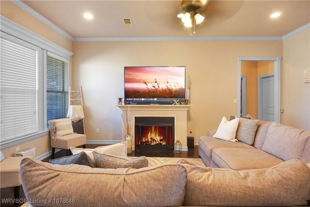 living room with ceiling fan and crown molding