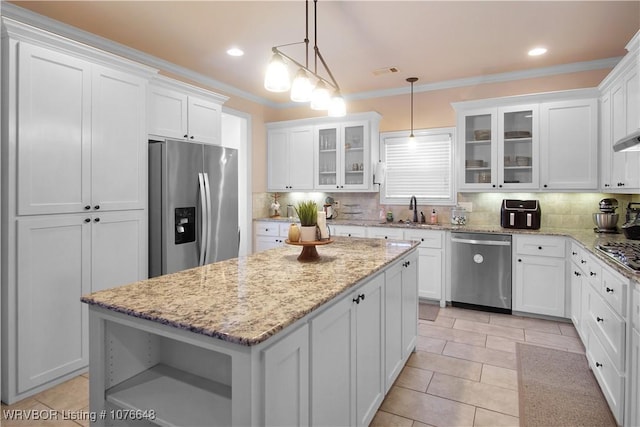 kitchen with a center island, pendant lighting, decorative backsplash, white cabinets, and appliances with stainless steel finishes