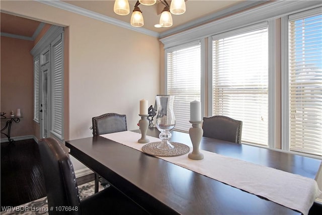 dining space featuring crown molding and an inviting chandelier